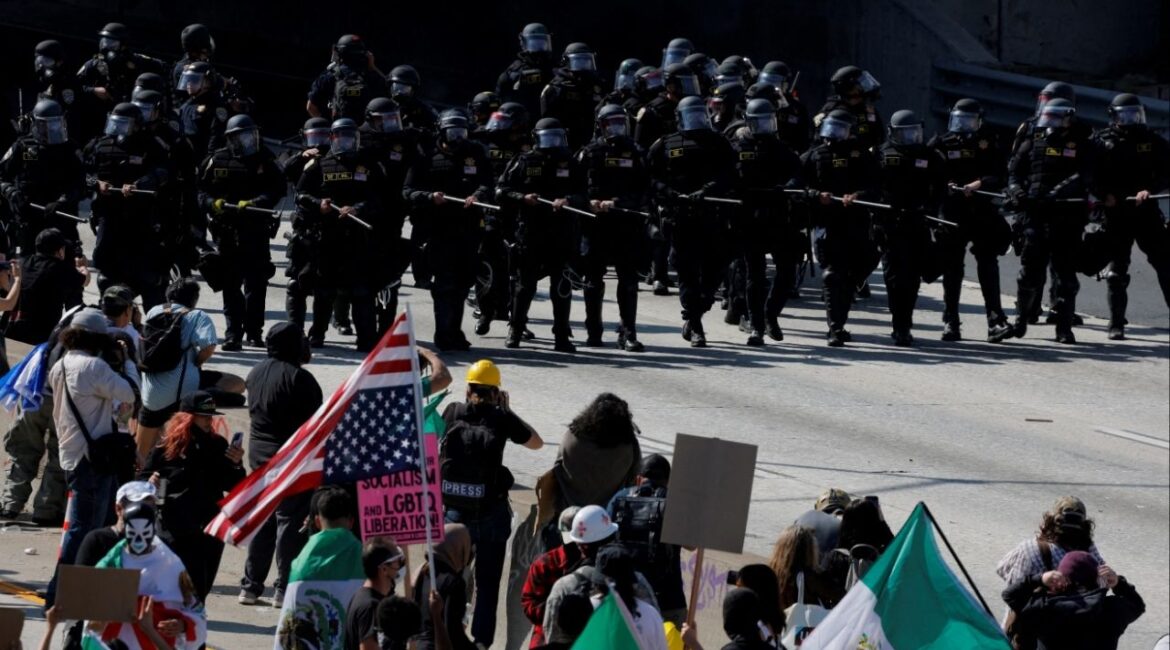 Police face off with demonstrators during a protest against federal immigration sweeps in downtown Los Angeles, California, U.S. June 8, 2025. REUTERS/Mike Blake