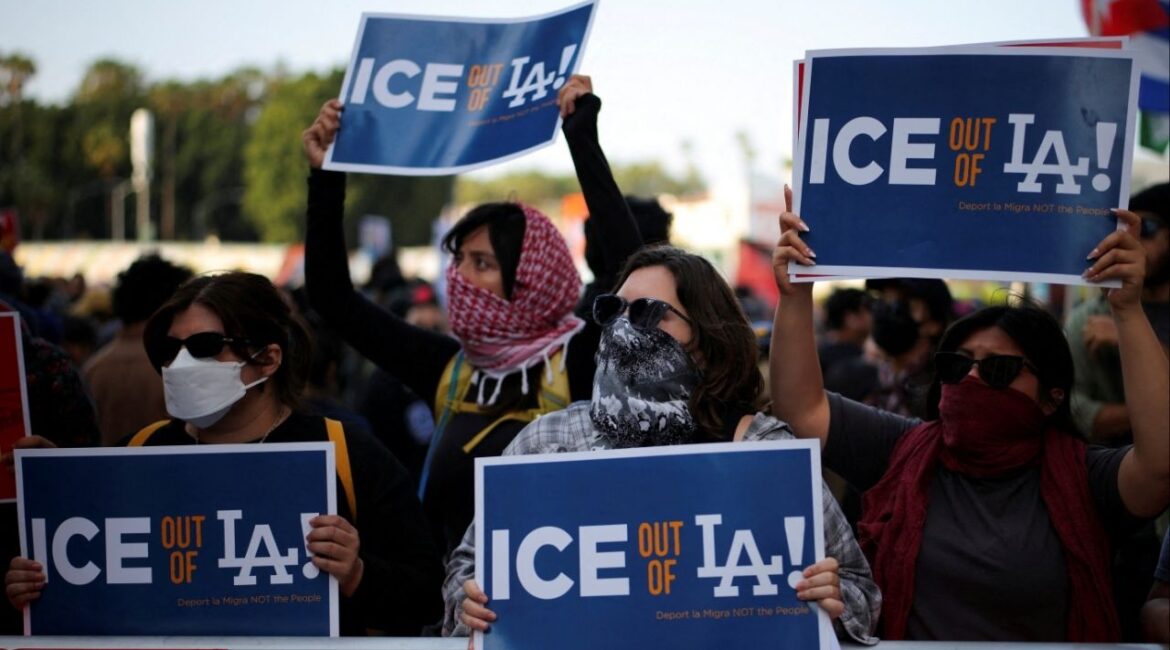 Protesters hold placards as they gather around the Los Angeles Federal Building following multiple detentions by Immigration and Customs Enforcement (ICE), in downtown Los Angeles, California, U.S., June 6, 2025. REUTERS/Daniel Cole