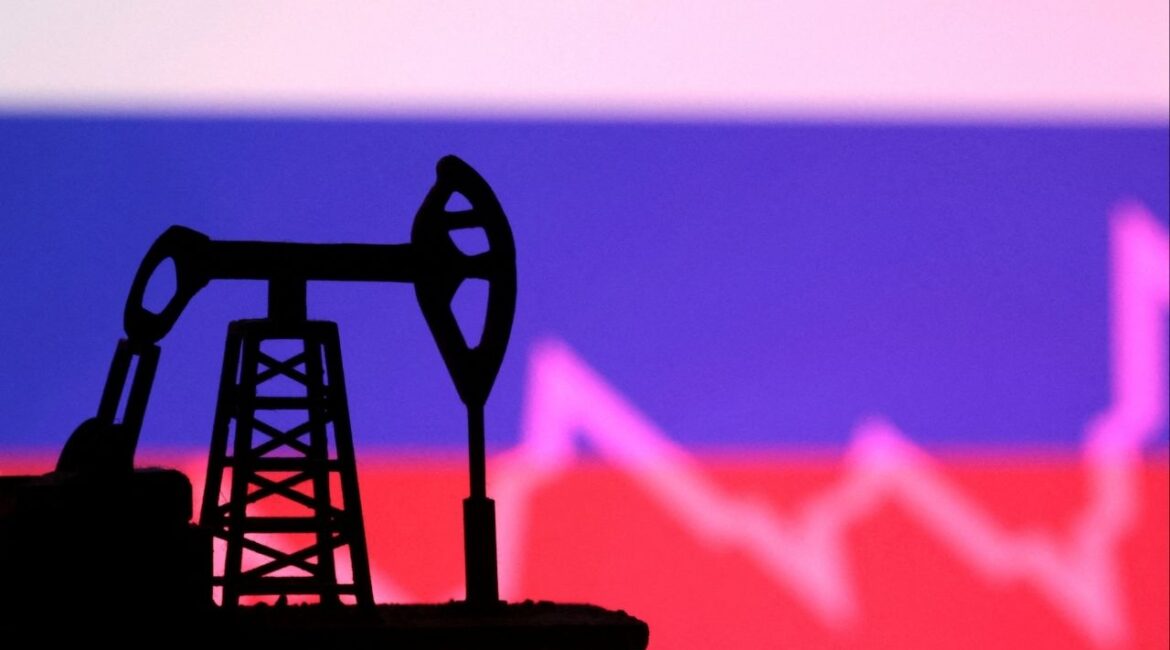 Russian flag with stock graph and an oil pump jack miniature model are seen in this illustration taken October 9, 2023. REUTERS/Dado Ruvic/Illustration/File photo
