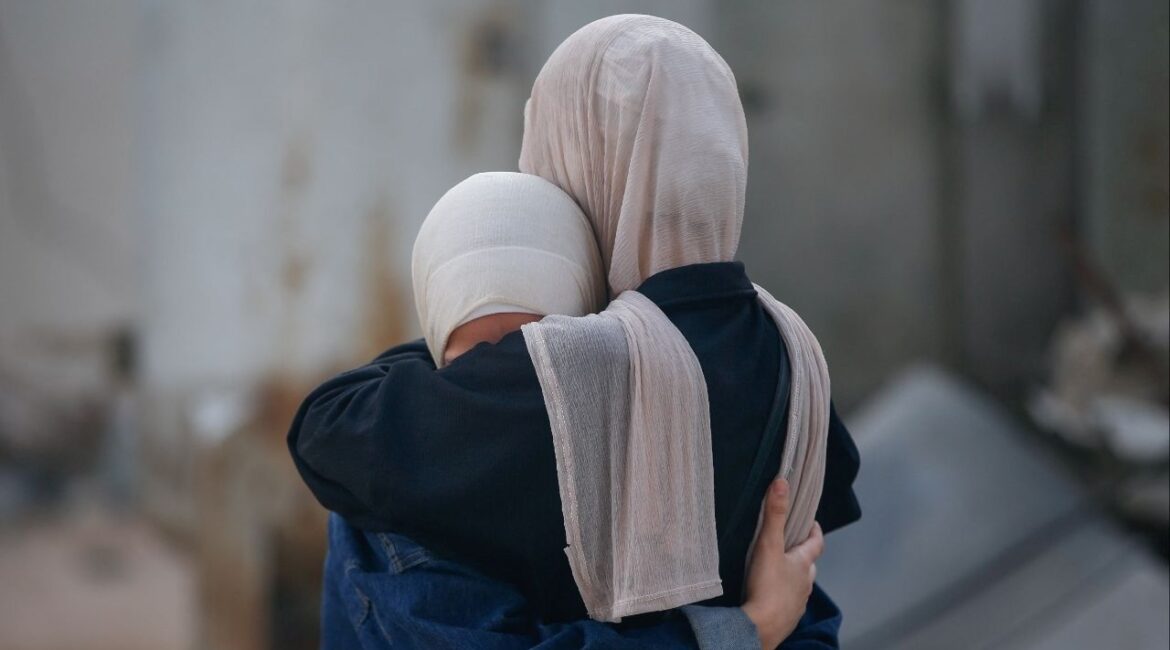 Women embrace, while mourning loved ones, during the funeral of Palestinians killed by Israeli fire yesterday, as they sought aid in northern Gaza, according to Gaza's health ministry, at Al-Shifa Hospital, in Gaza City, June 19, 2025. (Reuters File)