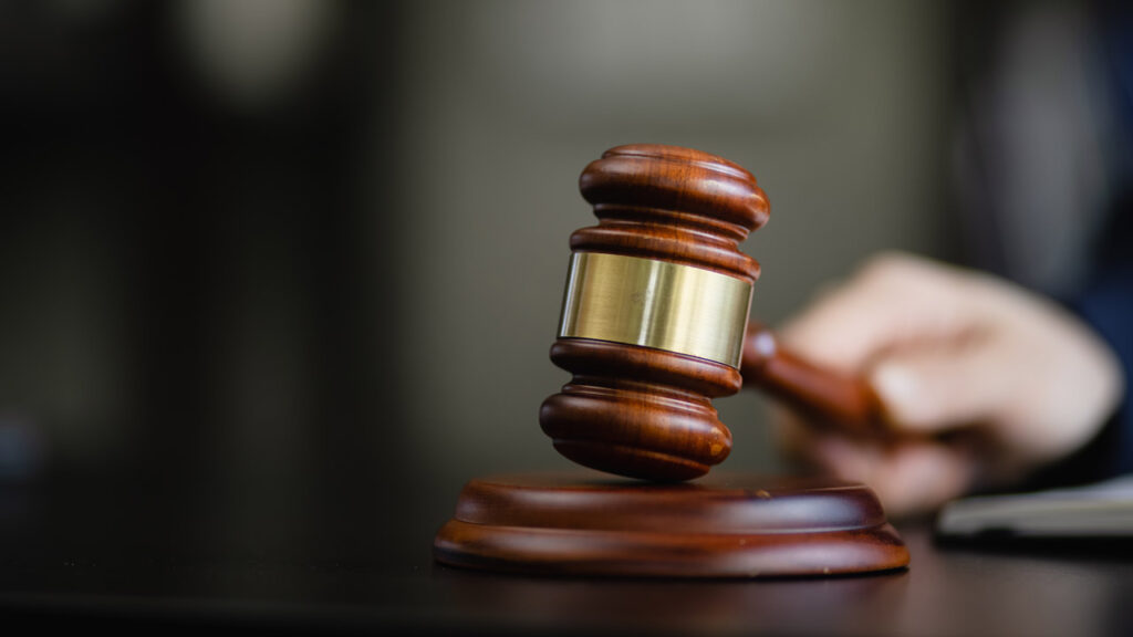 Image of hand pounding a gavel