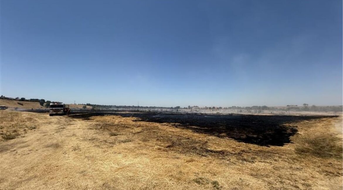 A 5-acre grass fire near the river bottom west of Woodward Park prompted brief evacuations Thursday, July 17, 2025, before being fully contained by Fresno fire crews. (GV Wire)