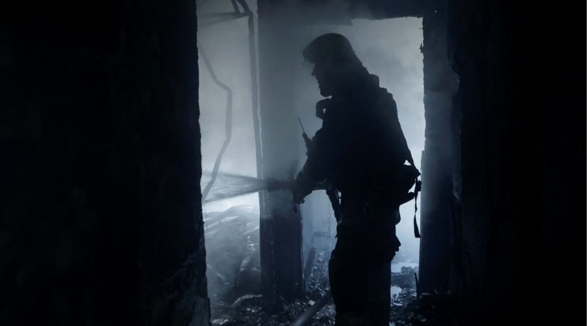 A firefighter works at the site of the building hit by a Russian drone strike, amid Russia's attack on Ukraine, in Kharkiv, Ukraine July 7, 2025. (Reuters/Sofiia Gatilova)