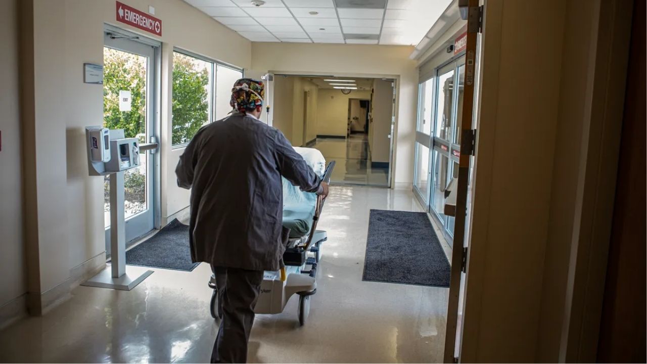 A medical worker pushing a bed through the corridors of Hazel Hawkins Memorial Hospital in Hollister on March 30, 2023. Photo by Larry Valenzuela, CalMatters/CatchLight Local