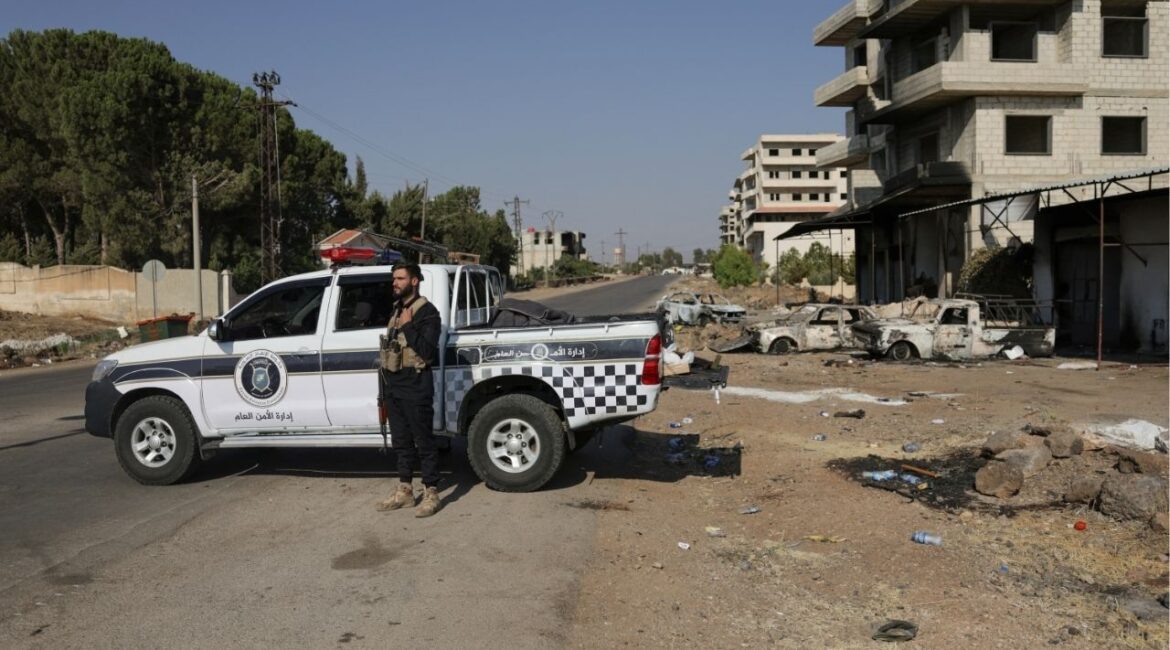 A member of the Internal Security Forces stands watch at a checkpoint in the village of Al-Mazra'a, after days of violence in the Sweida province sparked by clashes between Bedouin fighters and Druze factions, in Sweida province, Syria, July 21, 2025. (Reuters/Khalil Ashawi)