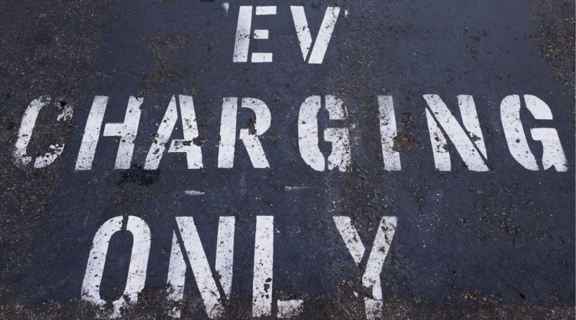 A parking space is marked specifically for an electric vehicle to charge charger in a shopping center parking lot in Oceanside, California, U.S., October 19, 2023. (Reuters File)