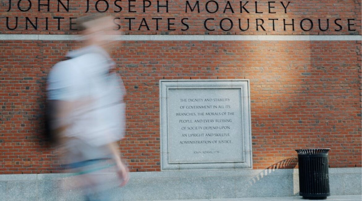 A pedestrian passes the federal courthouse where Harvard University is urging a federal judge to order U.S. President Donald Trump's administration to restore about $2.5 billion in canceled federal grants and cease efforts to cut off research funding, in Boston, Massachusetts, U.S., July 21, 2025. (Reuters/Brian Snyder)