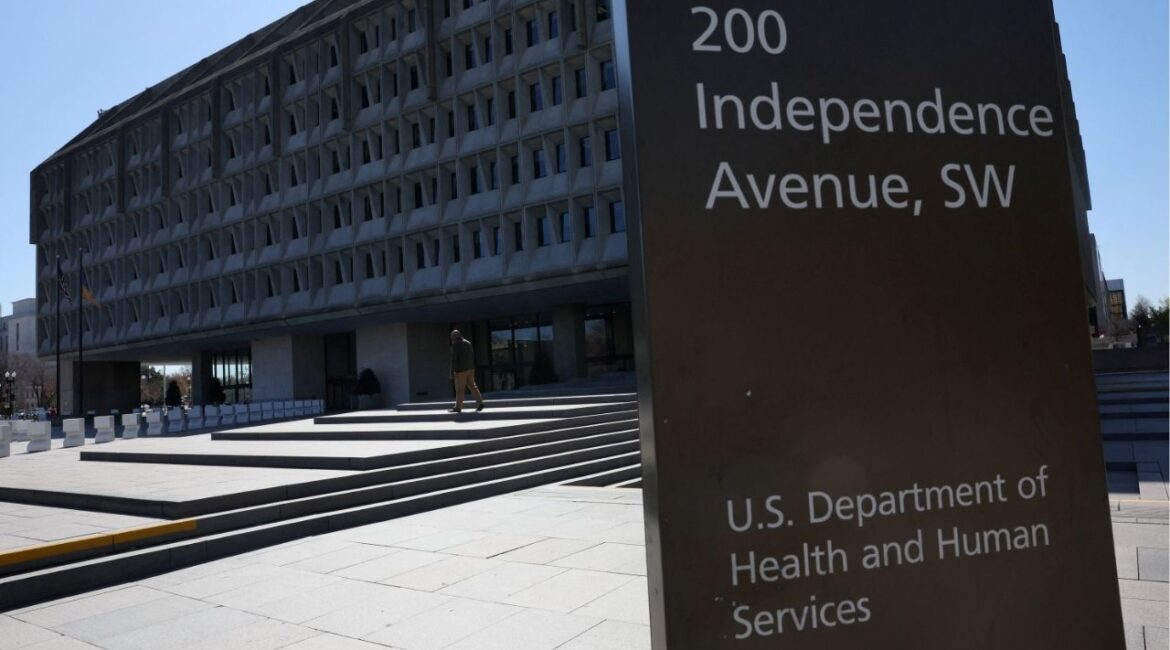A person walks outside of the U.S. Department of Health and Human Services building after it was reported that the HHS will cut about 10,000 full-time jobs and close half of its regional offices, a major overhaul of the department under Health Secretary Robert F. Kennedy Jr., in Washington, D.C., U.S., March 27, 2025. (Reuters/Leah Millis)