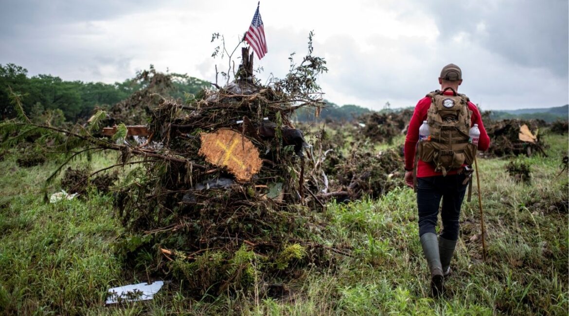 A volunteer searches for flood victims after deadly flooding in Kerr County, Texas, U.S., July 6, 2025. REUTERS/Sergio Flores