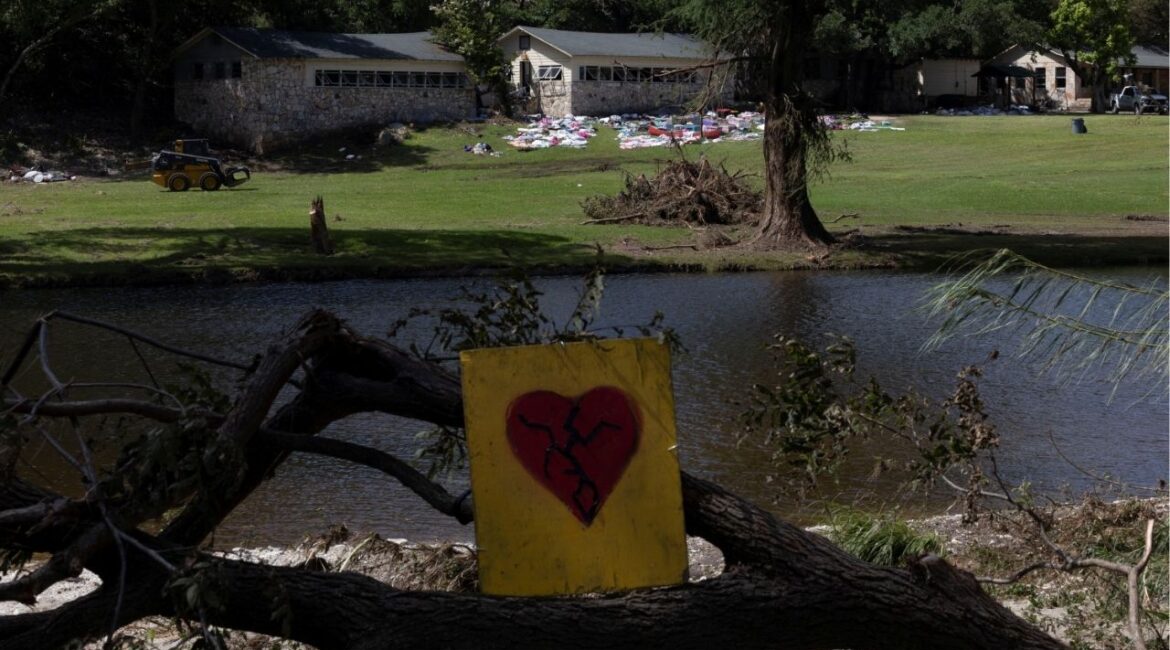 An image of a cracked heart is placed on a collapsed tree by the Guadalupe River, across from Camp Mystic, following deadly flooding, in Hunt, Texas, U.S., July 10, 2025. REUTERS/Umit Bektas TPX IMAGES OF THE DAY