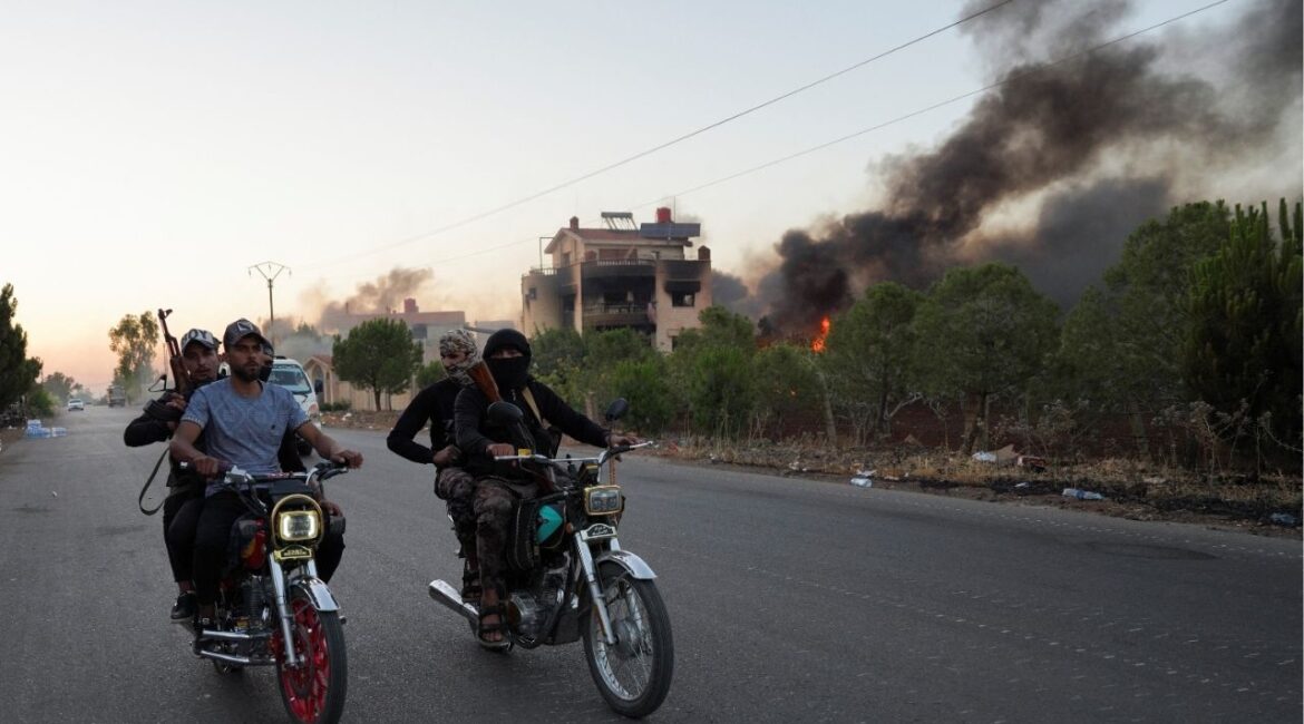 Bedouin fighters ride on motorbikes along a street, as Sweida province has been engulfed by nearly a week of violence triggered by clashes between Bedouin fighters and factions from the Druze, at Sweida governorate, Syria, July 18, 2025. (Reuters/Karam al-Masri)