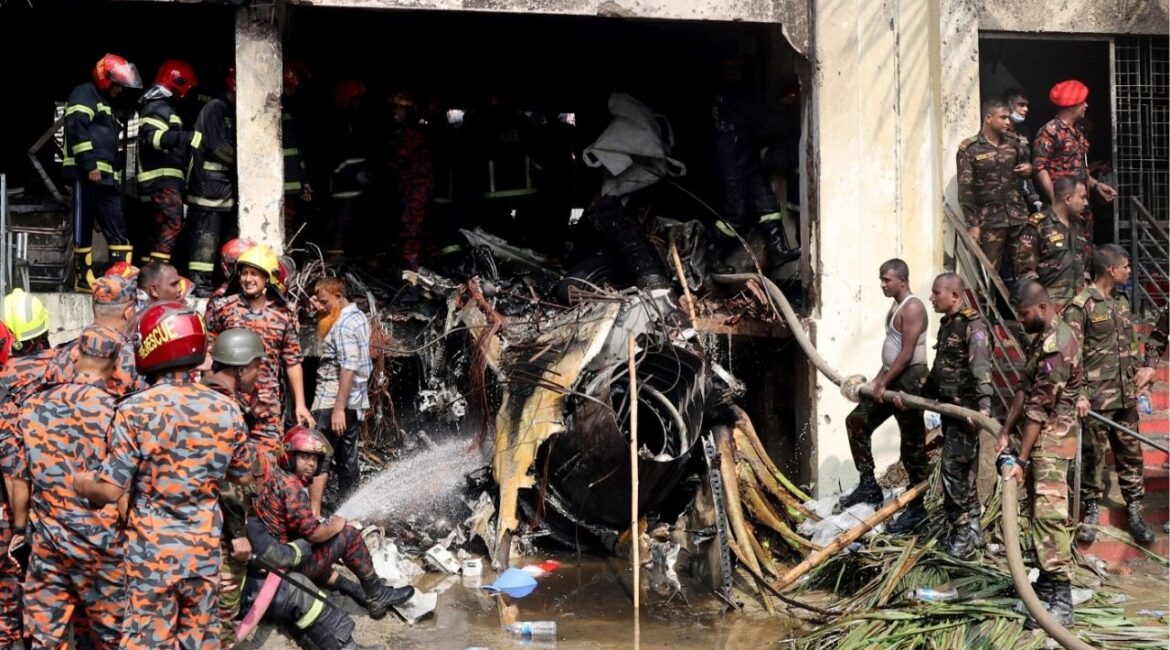 Firefighters and army members work next to the wreckage of an air force training aircraft after it crashed into Milestone College campus, in Dhaka, Bangladesh, July 21, 2025. REUTERS/Stringer