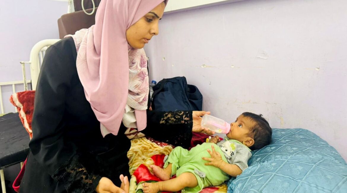 Mother Feeds Her Infant Daughter in central Gaza July 2025