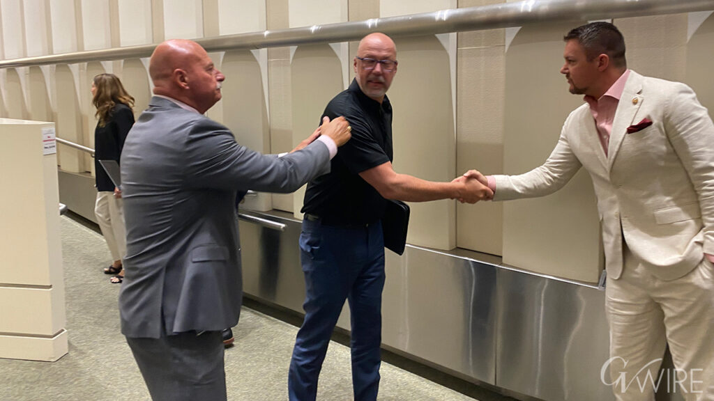 Mayor Jerry Dyer watches as FPOA President Jeff LaBlue shakes hands with City Councilmember Nick Richardson.