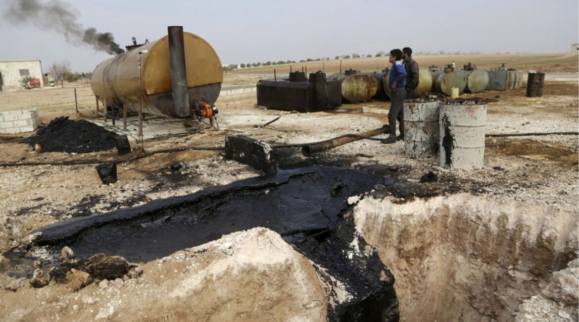 Men work at a makeshift oil refinery site in Marchmarin town, southern countryside of Idlib, Syria December 16, 2015. (Reuters File)