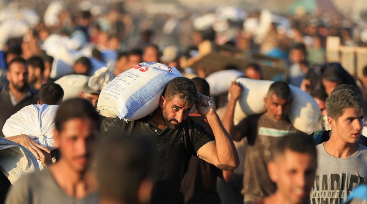 Palestinians carry aid supplies that entered Gaza through Israel, in Beit Lahia in the northern Gaza Strip, July 30, 2025. (Reuters File)
