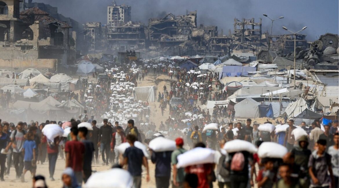 Palestinians gather as they carry aid supplies that entered Gaza through Israel, amid a hunger crisis, in Beit Lahia in the northern Gaza Strip July 20, 2025. REUTERS/Dawoud Abu Alkas