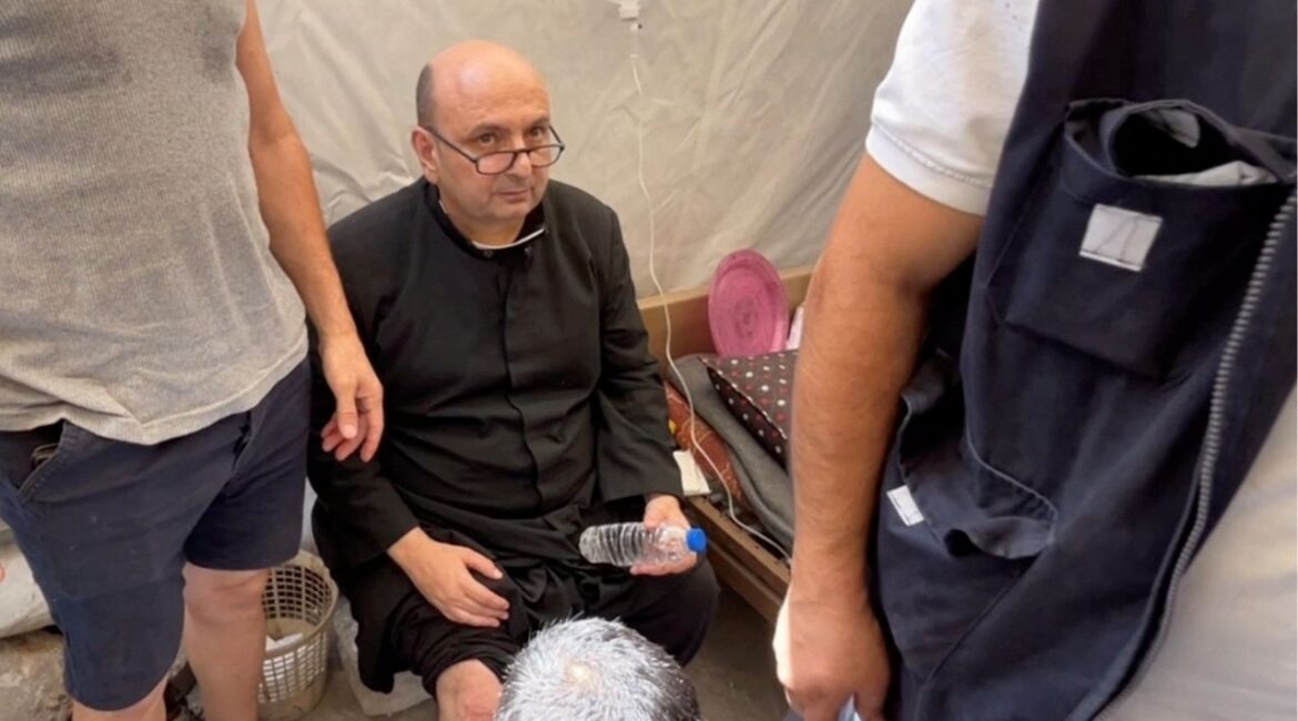 Parish priest of the Church of the Holy Family, father Gabriele Romanelli, receives medical attention, after he suffered light leg injuries following an Israeli strike on the church, according to medics, at Al-Ahli Arab Hospital in Gaza City, in this still image taken from a video July 17, 2025. REUTERS/Dawoud Abu Alkas