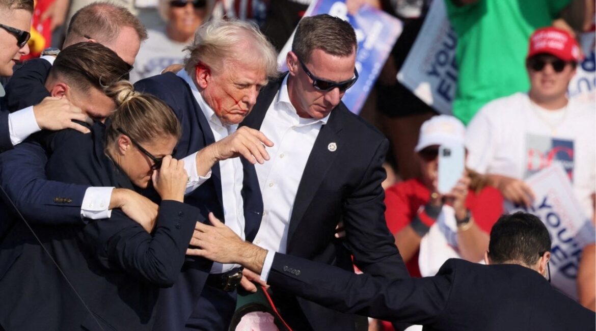 Republican presidential candidate and former U.S. President Donald Trump with his bloodied face is assisted by the Secret Service as multiple shots rang out during a campaign rally at the Butler Farm Show in Butler, Pennsylvania, U.S., July 13, 2024. (AP File)