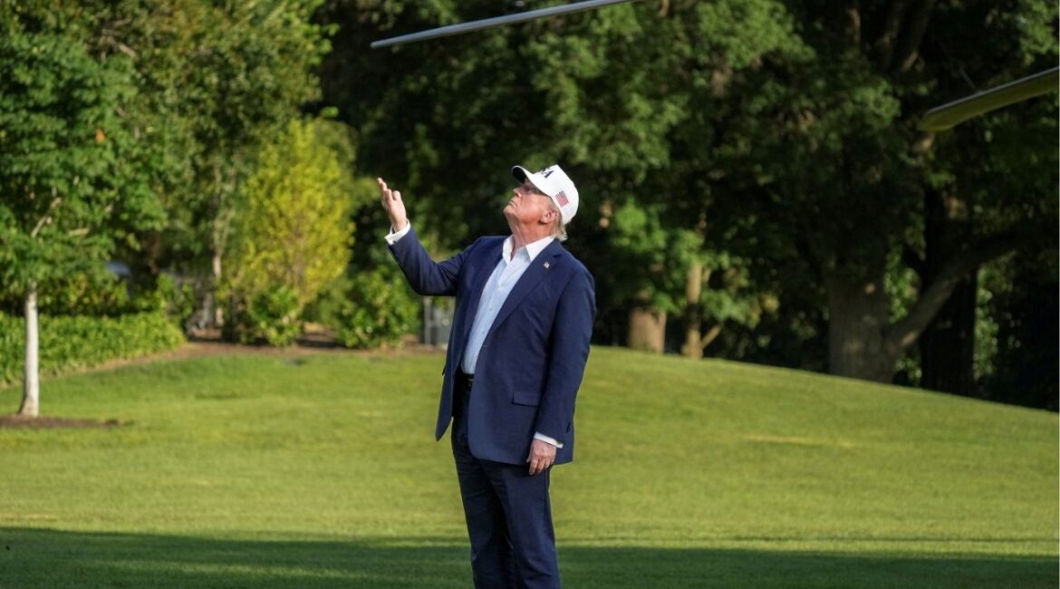 U.S. President Donald Trump gestures to the U.S. flag flying on a new flagpole after stepping off Marine One returning from New Jersey at the White House in Washington, D.C., U.S., July 6, 2025. (Reuters/Ken Cedeno)