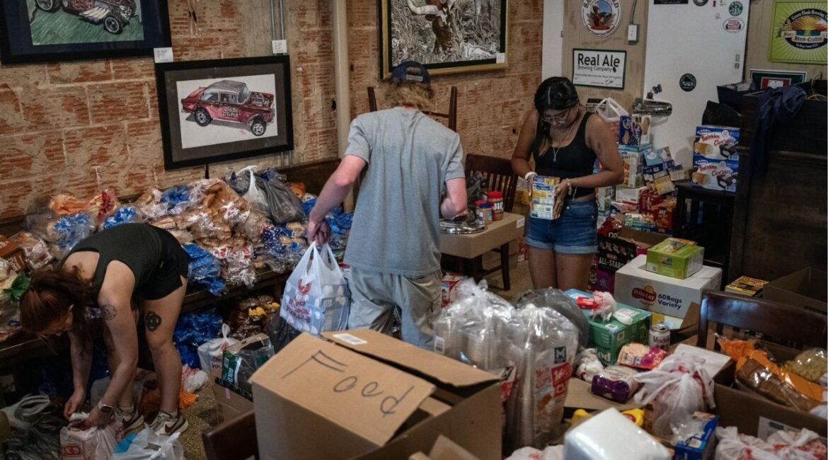 Volunteers pack supplies for impacted residents at a donation hub in Kerrville, Texas, on Monday, July 7, 2025. Gov. Greg Abbott revealed late Tuesday that at least 173 people remained missing after the devastating floods — the first time state officials have identified just how widespread the human toll might eventually be. (Loren Elliott/The New York Times)