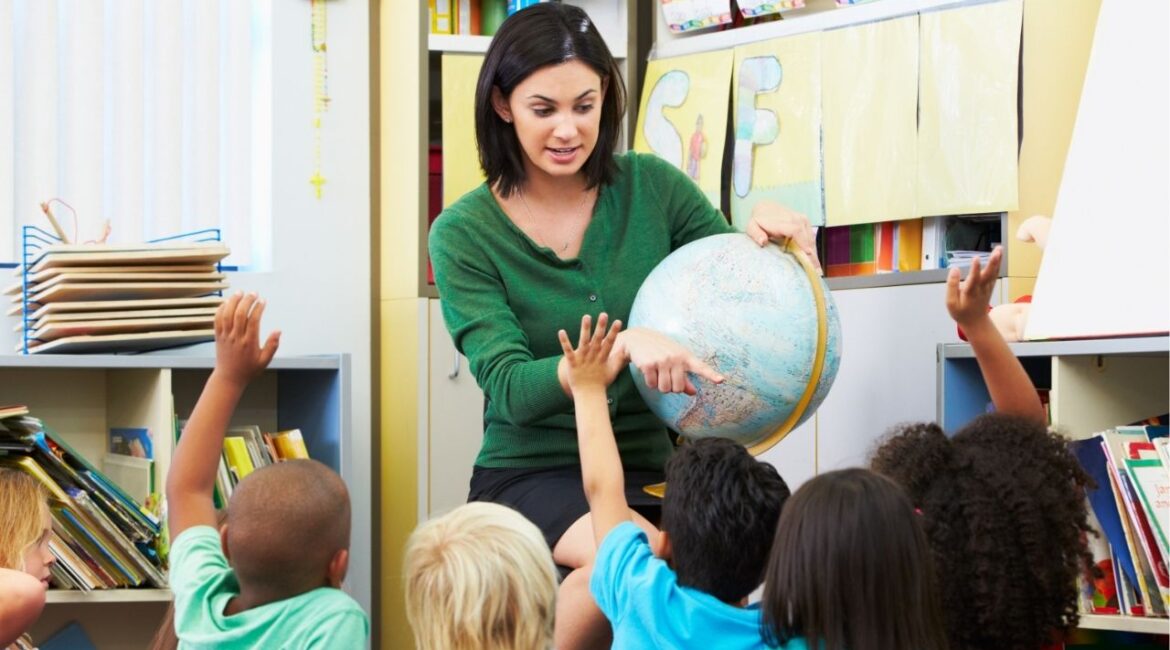 Teacher Uses Globe While Instructing Her Students