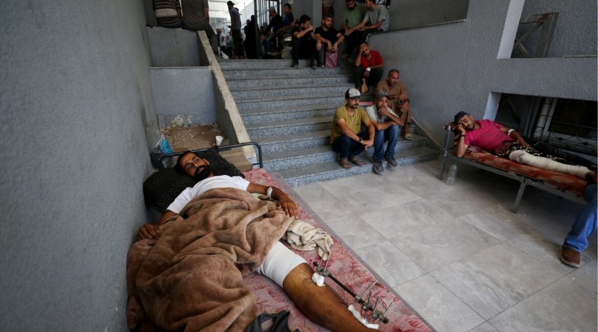 Wounded Palestinians lie on beds at Al-Shifa Hospital, which Gaza's health ministry says is at risk of shutting down due to the Israeli blockade of fuel, in Gaza City July 9, 2025. (Reuters/Mahmoud Issa)