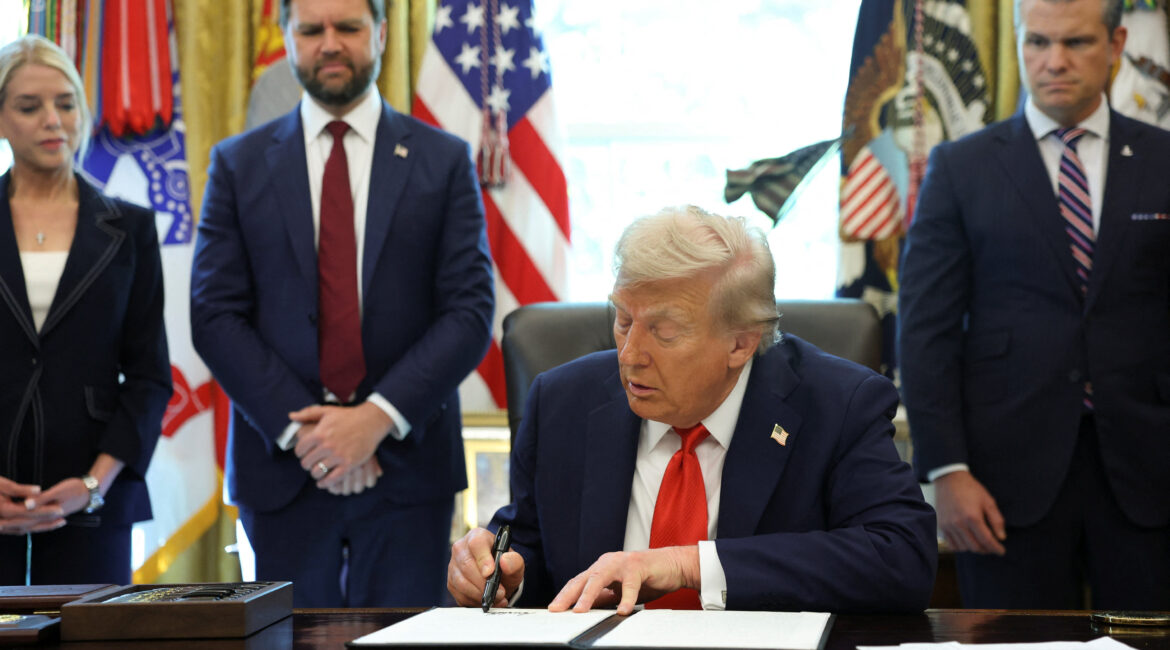 President Donald Trump signs an executive order at the Resolute Desk in the Oval Office of the White House in Washington, D.C., on August 25, 2025.