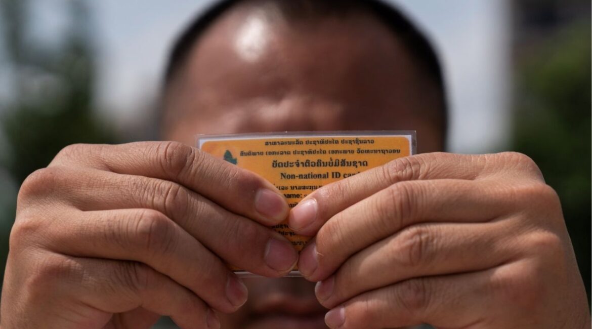 A Lao man deported from the U.S. holds up his non-national ID card - a document that defines his legal status in the country he left behind decades ago, and to which he has now returned, in Vientiane, Laos, July 31, 2025. REUTERS/Phoonsab Thevongsa