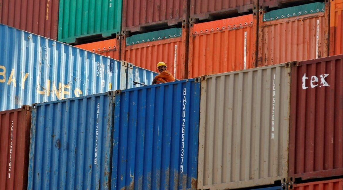 A worker sits on a ship carrying containers at Mundra Port in the western Indian state of Gujarat April 1, 2014. (Reuters File)