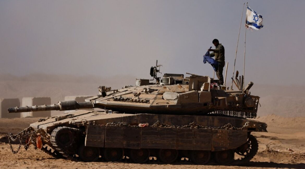 An Israeli soldier stands on a tank on the Israeli side of the border with Gaza, Israel August 20, 2025. (Reuters/Amir Cohen)