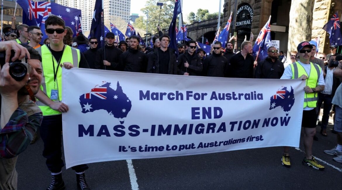 Demonstrators hold a banner during the 'March for Australia' anti-immigration rally, in Sydney, Australia, August 31, 2025. REUTERS/Hollie Adams