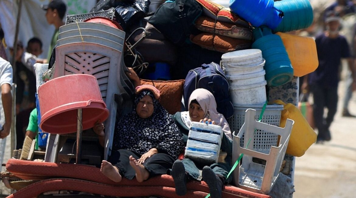 Displaced Palestinian women fleeing northern Gaza ride with their belongings as they head south, amid an Israeli military operation, in Gaza City, August 21, 2025. (Reuters/Dawoud Abu Alkas)