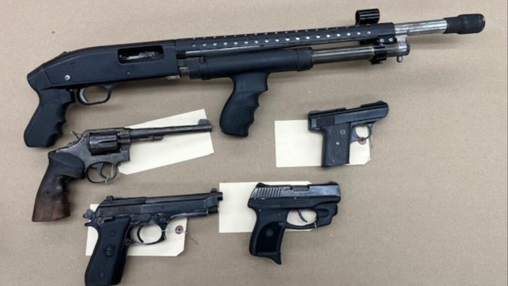 Fresno police discovered two narcotics labs, multiple firearms, and operating slot machines during a probation check, leading to three arrests. (Fresno PD)