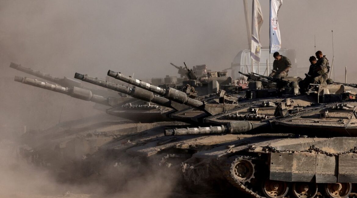 Israeli soldiers sit on top of tanks at the Israel-Gaza border, as seen from Israel, August 26, 2025. (Reuters/Amir Cohen)