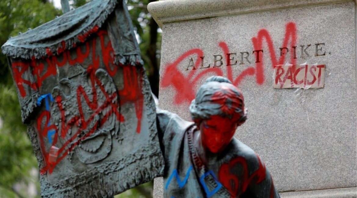 Messages of protest remain after protesters toppled the statue of Albert Pike, amid a series of racial inequality protests, at the Brigadier General Albert Pike Statue site near Capitol Hill in Washington, U.S., July 7, 2020. (Reuters File)