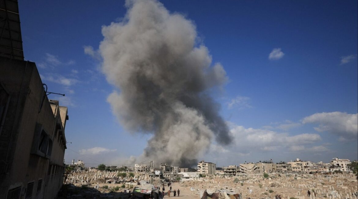 Palestinians gather near a cemetery as smoke rises following an explosion during an Israeli operation in Gaza City, August 28, 2025. (reuters/Dawoud Abu Alkas)
