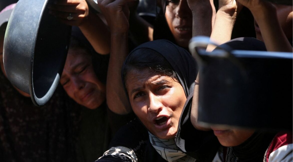 Palestinians wait to receive food from a charity kitchen, amid a hunger crisis, in Khan Younis, southern Gaza Strip, August 4, 2025. (Reuters/Hatem Khaled)