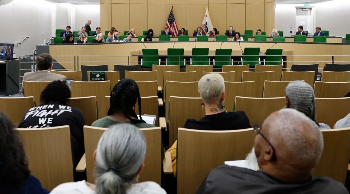 People listen during a hearing of the suspense file in the Assembly Appropriations Committee at the Capitol Annex Swing Space in Sacramento on Aug. 29, 2025. Photo by Fred Greaves for CalMatters