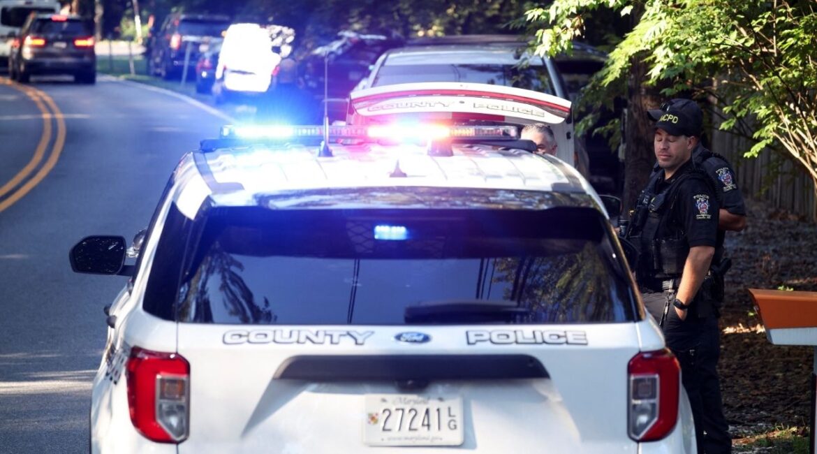 Police officers stand outside the home of the former White House national security adviser John Bolton as it is searched by FBI members, in Bethesda, Maryland, U.S., August 22, 2025. (Reuters/Tasos Katopodis)