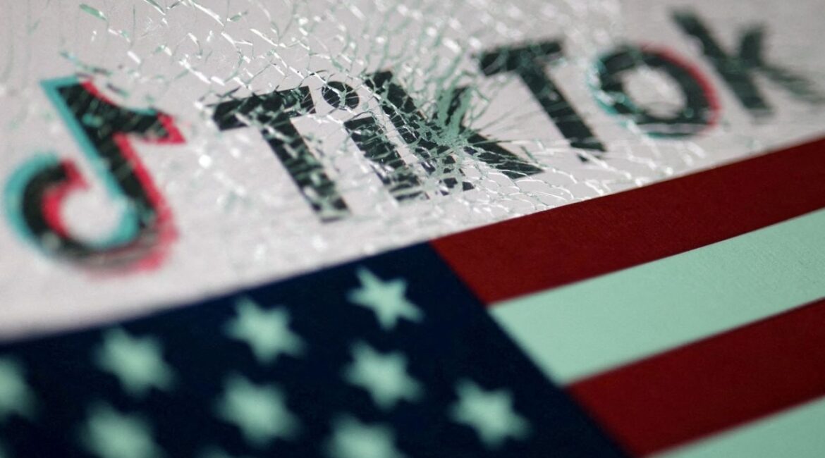 The U.S. flag and the TikTok logo seen through broken glass are seen in this illustration taken January 16, 2025. (Reuters File)