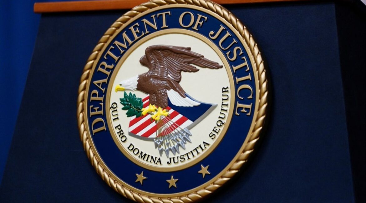 The seal of the U.S. Justice Department is seen on the podium in the Department's headquarters briefing room before a news conference with the Attorney General in Washington, January 24, 2023. (Reuters File)