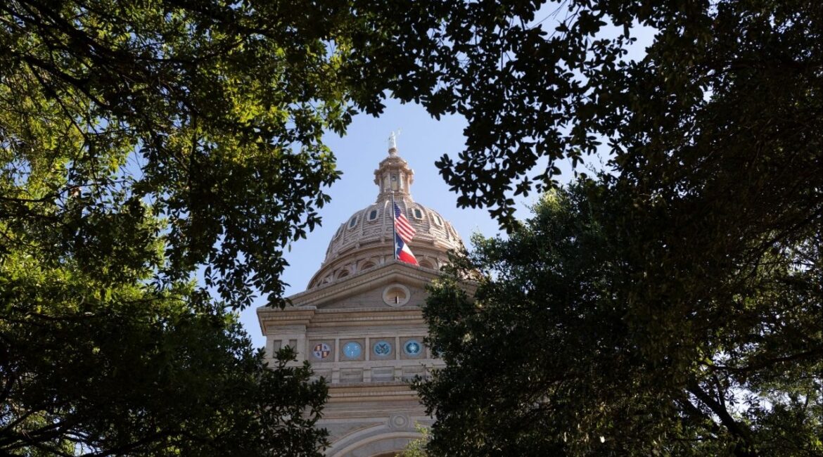 U.S. and Texas state flags fly at the Texas Capitol building, amid a redistricting battle between Republicans and Democratic state lawmakers in Austin, Texas, U.S., August 18 2025. (Reuters/Nuri Vallbona)