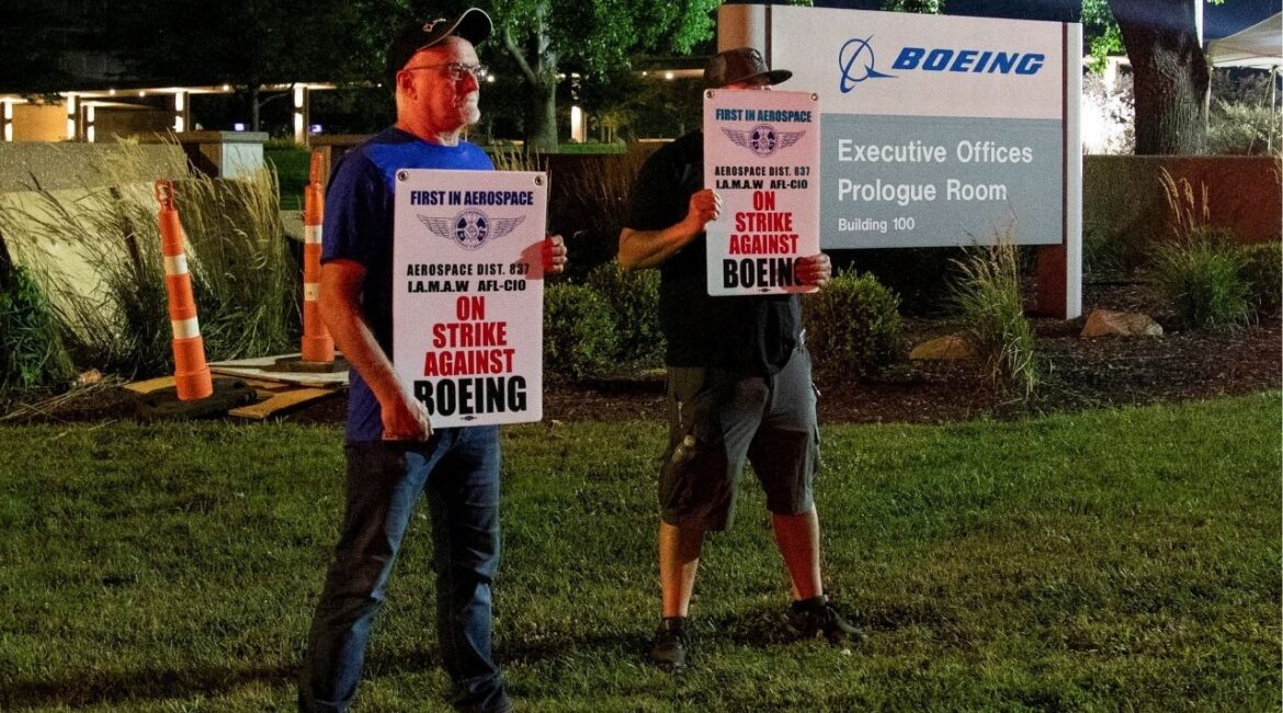 Workers display picket signs, as they protest during a walkout by members of the International Association of Machinists and Aerospace Workers (IAM) over contract negotiations, outside Boeing company's facility, in Berkeley, Missouri, U.S., August 4, 2025 (Reuters/Lawrence Bryant)