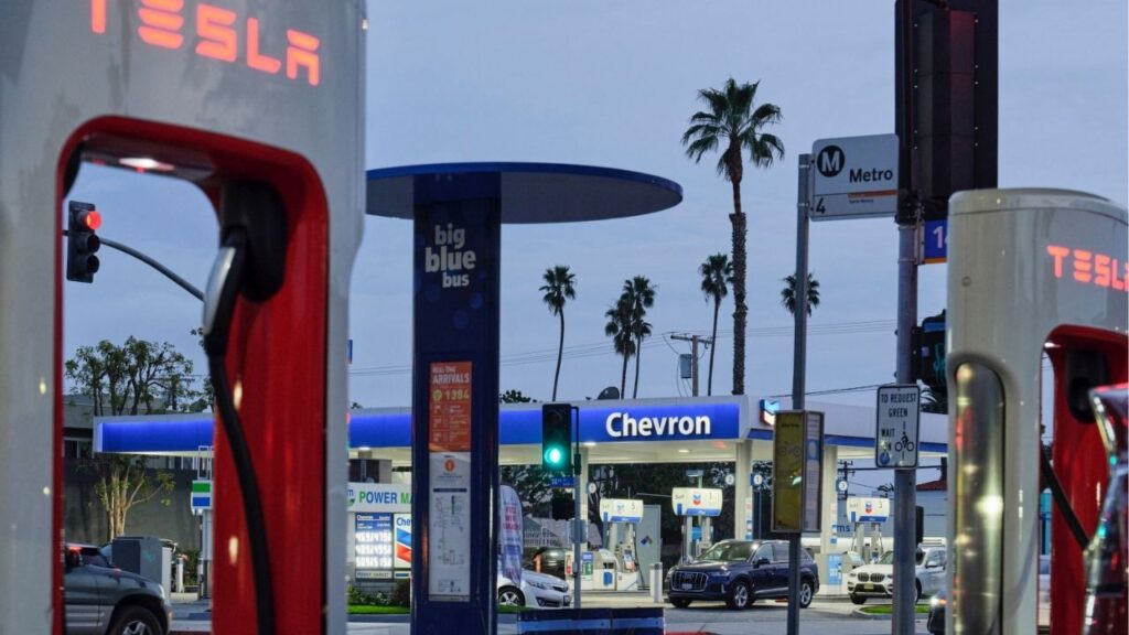 A Chevron gas station is seen across the street from a Tesla Supercharger, an electric vehicle charging station in Santa Monica, Calif. on Jan. 24, 2024. California leaders have envisioned a time when most drivers have electric cars, but a vast majority of residents still rely on gas-powered vehicles. (Philip Cheung/The New York Times)