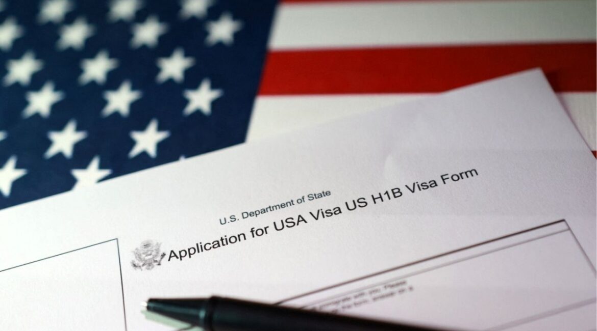 A U.S. flag and a U.S. H-1B Visa application form are seen in this illustration taken, September 22, 2025. (Reuters/Dado Ruvic/Illustration)