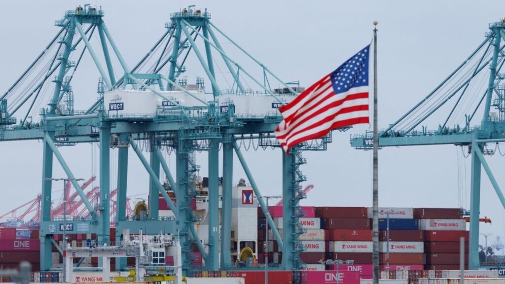 A U.S. flag flutters near shipping containers as a ship is unloaded at the Port of Los Angeles, in San Pedro, California, U.S., May 1, 2025. (Reuters File)