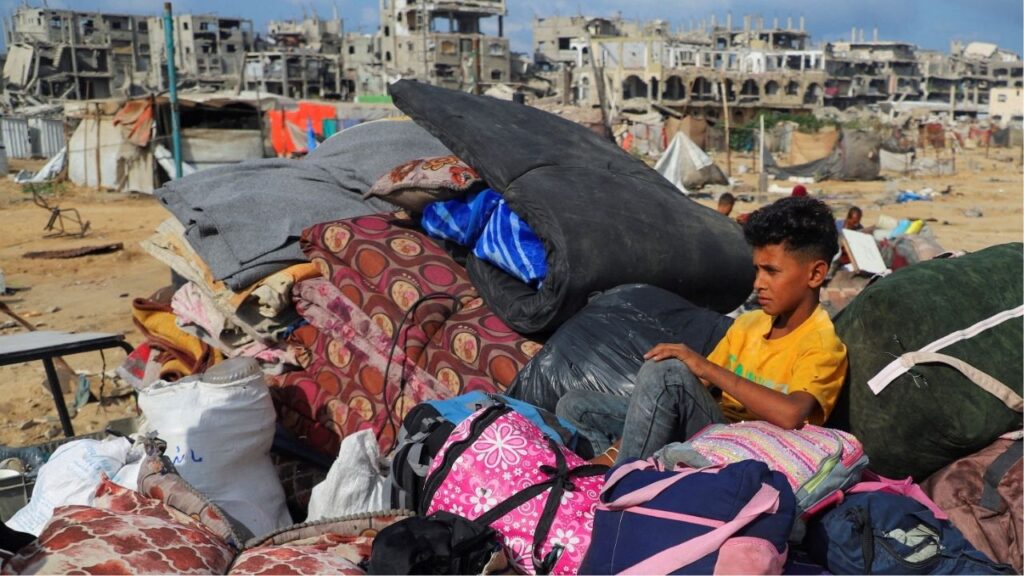 A boy sits on top of a pile of belongings, as displaced Palestinians get ready to flee, amid an Israeli military operation, after Israeli forces ordered residents of Gaza City to evacuate to the south, in Gaza City, September 19, 2025. (Reuters/Ebrahim Hajjaj)
