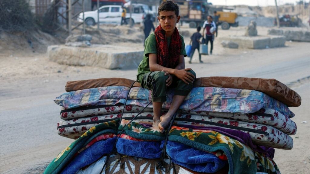 A displaced Palestinian boy, fleeing northern Gaza due to an Israeli military operation, sits atop belongings as he moves southward after Israeli forces ordered residents of Gaza City to evacuate to the south, in the central Gaza Strip September 17, 2025. (Reuters/Mahmoud Issa)