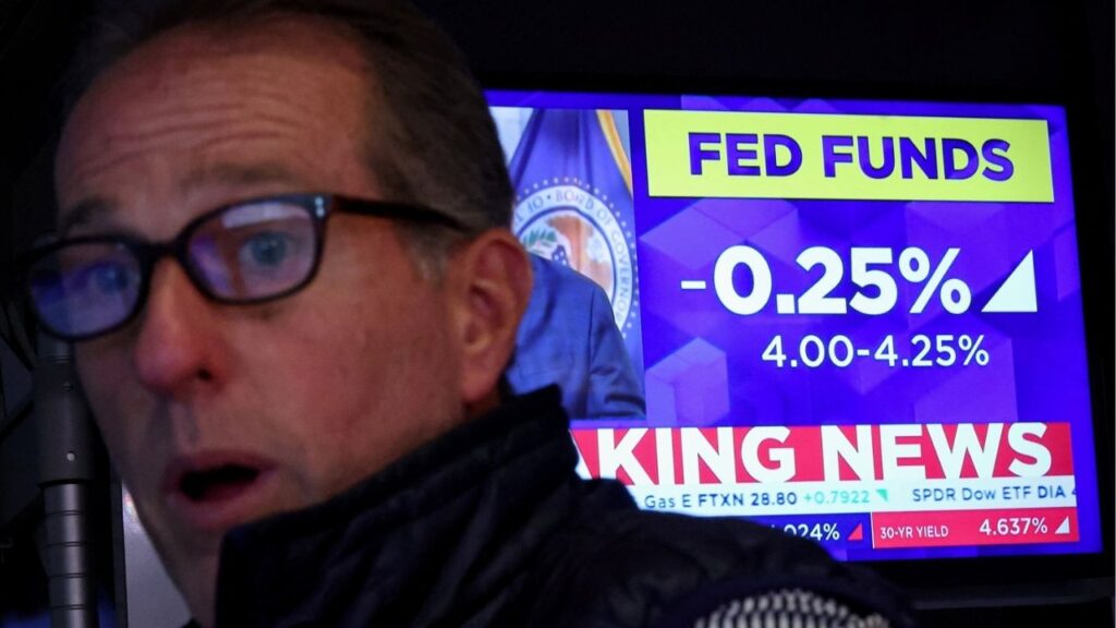 A specialist trader reacts, as a screen displays the Fed rate announcement on the floor of the New York Stock Exchange (NYSE) in New York City, U.S., September 17, 2025. (Reuters/Brendan McDermid)